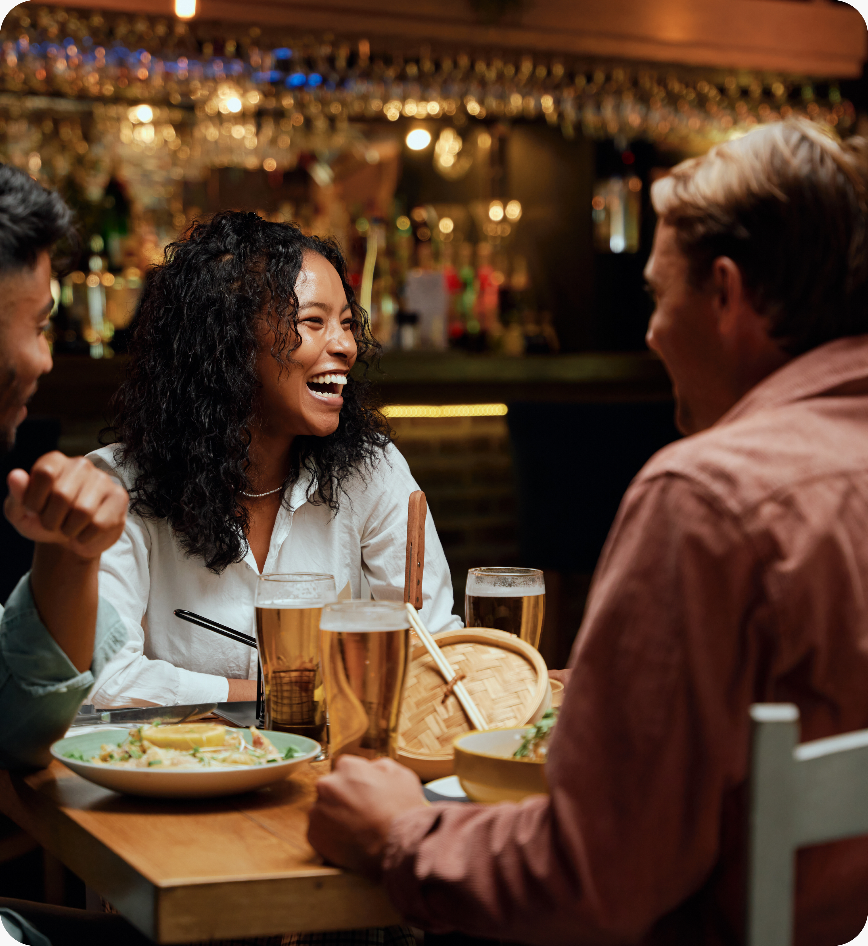 Friends laughing together over dinner