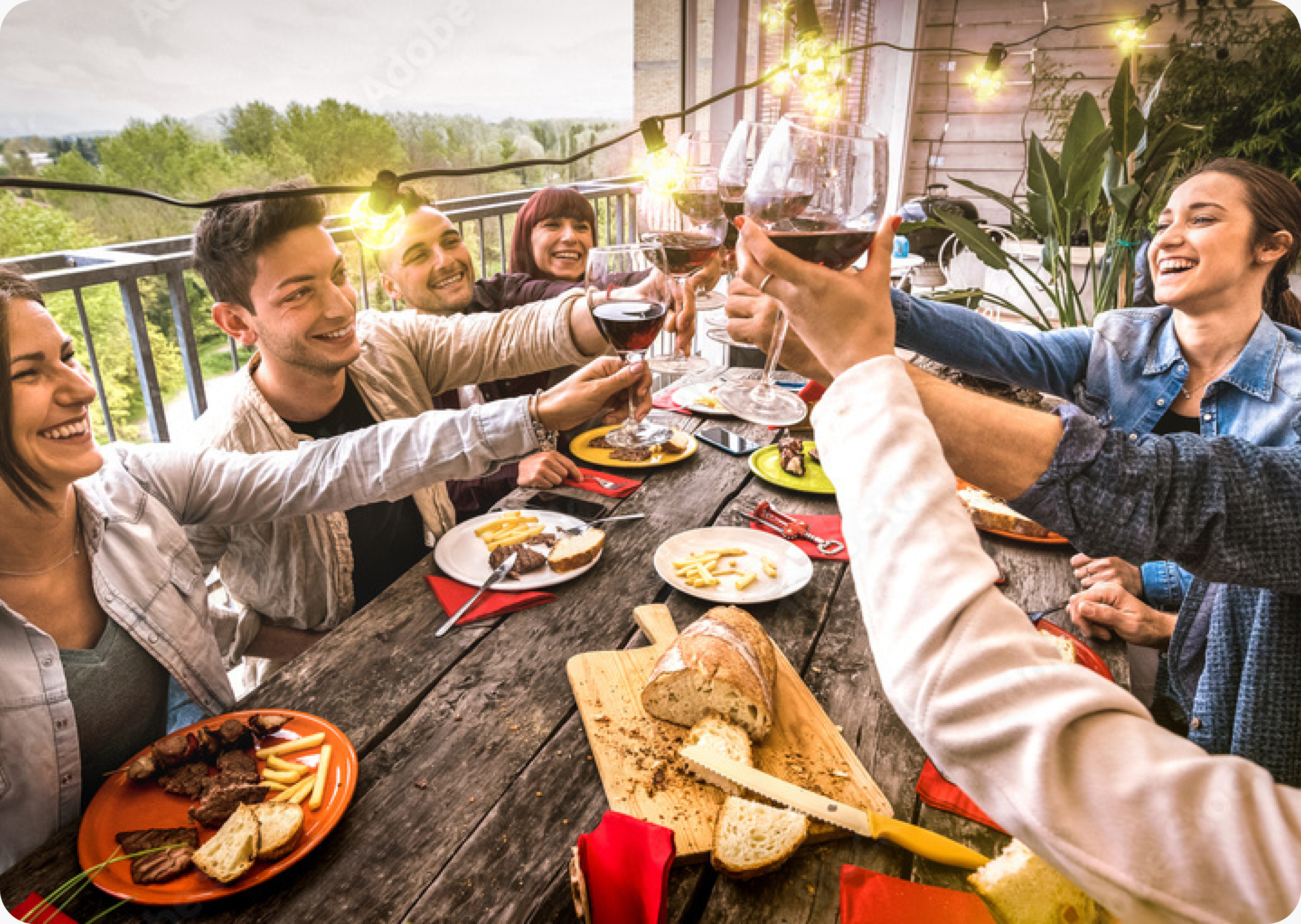 Friends sharing a toast over food outdoors